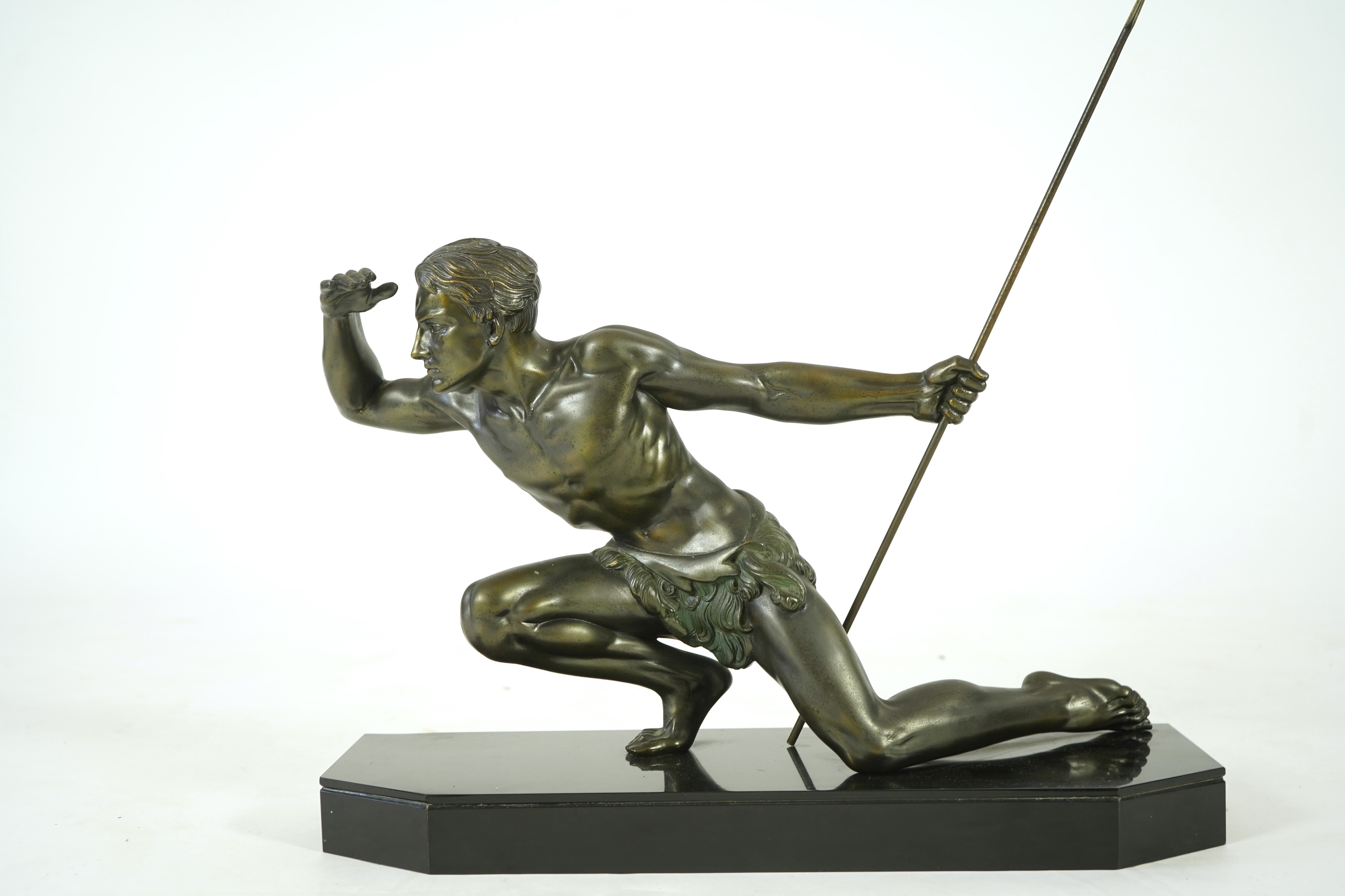 Manner of Jean de Roncourt (1869-1937) An Art Deco patinated bronze sculpture of a male hunter with spear on black marble stand